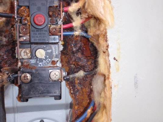 Corrosion around upper thermostat with melted lower left terminal.JPG