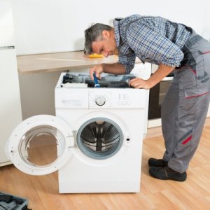 Technician Repairing Washing Machine