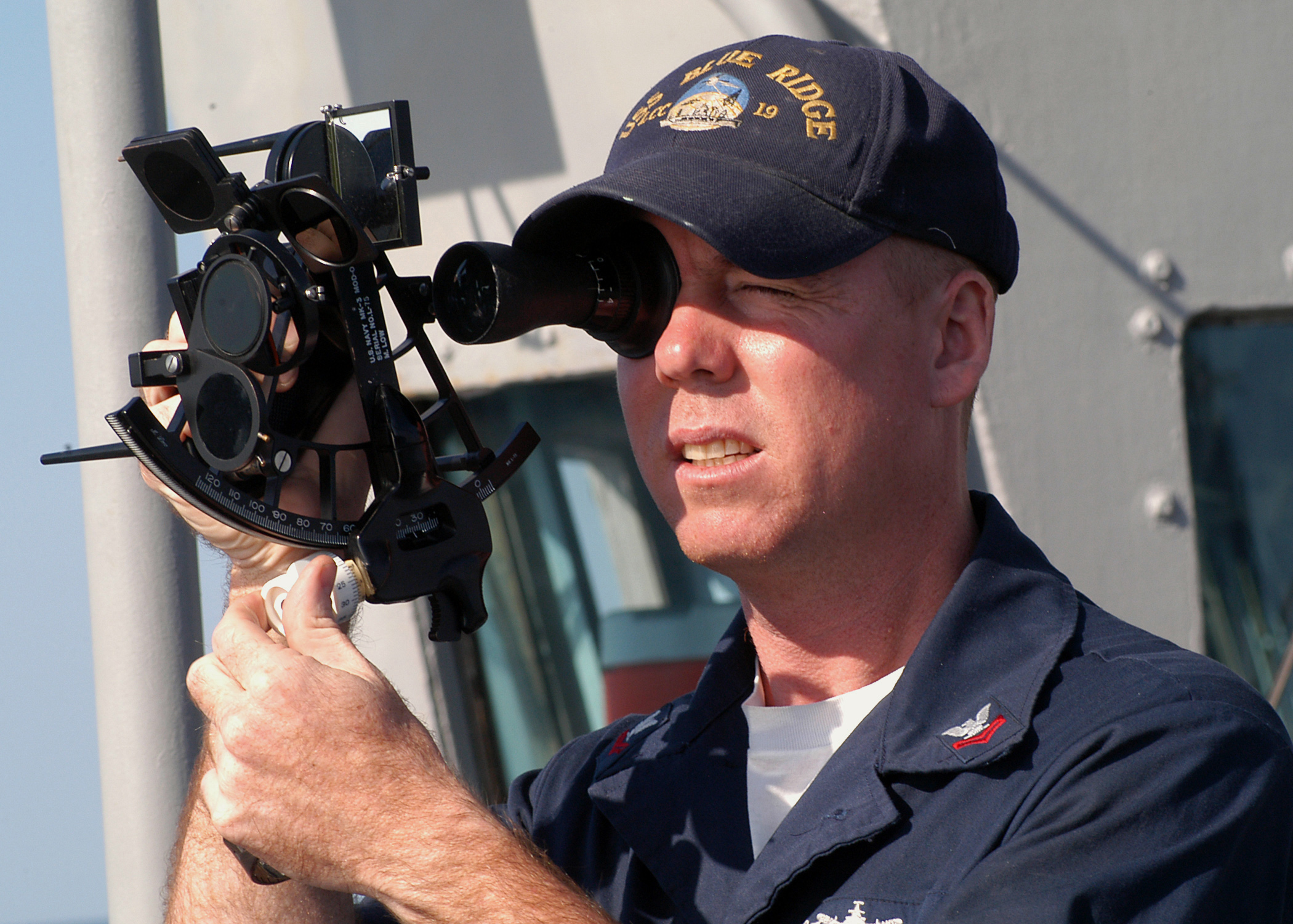 US_Navy_031025-N-8955H-005_Quartermaster_2nd_Class_Martineau,_from_Ft._Lauderdale,_Fla.,_uses_a_sextant_to_shoot_the_sun_line_from_the_port_bridge_wing_of_USS_Blue_Ridge_(LCC_19).jpg