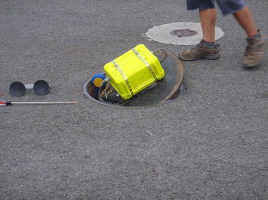 Street sewer alarm control box with blue and yellow float valve upside down on left.JPG